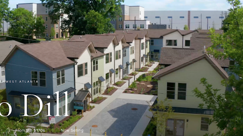 An image of rows of new modern homes in Atlanta new wide streets and apartment with many exterior colors and modern white interiors. 
