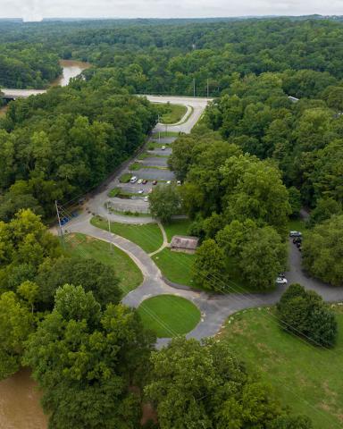 An image of a large greenspace beside a river where a new park is planned.