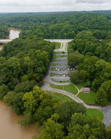 An image of a large greenspace beside a river where a new park is planned.