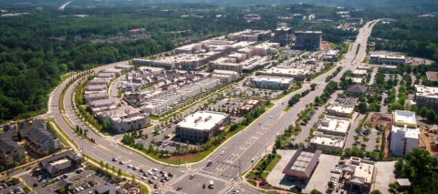 A huge development in north suburban Atlanta shown near many forested areas and big highways.