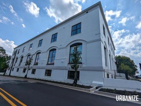 A small brick condo building under blue skies near Atlanta.